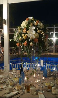 Flower arrangement for reception table on big glass vase.