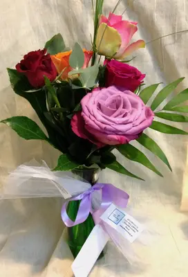 Mixed colored roses (5) stems in vase with colored water and gel.