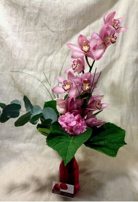 Vase with cymbidium orchid