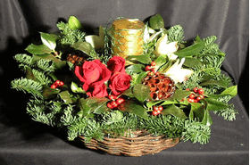Christmas arrangement in basket with candle