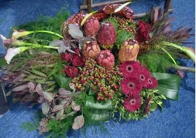 Condolences arrangement with exclusive tropical and seasonal flowers