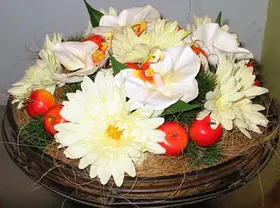 Artificial flower arrangement in vintage iron + glass pot
