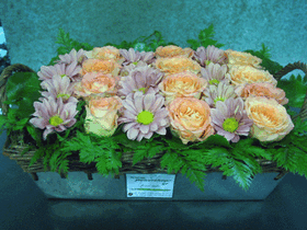 Basket arrangement with flowers in rows