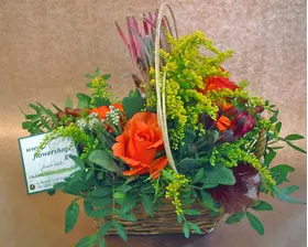 Season flowers arrangement in small basket