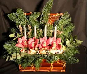 Christmas arrangement in basket with candles