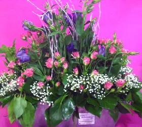 Flower arrangement in vertical line .Metallic pot.