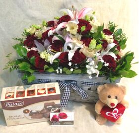 Exclusive arrangement with red roses (30)st. & Oriental Lillies + Chocolates + Teddy Bear.
