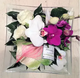 Exclusive season flowers in glass tray arrangement