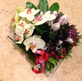 Exclusive season flowers in glass tray arrangement