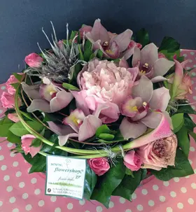 Exclusive season flowers in glass tray arrangement