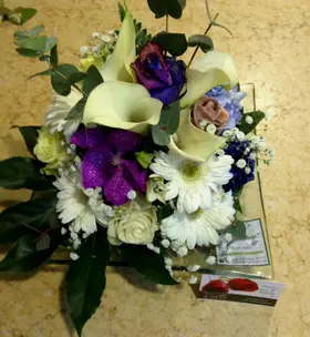 Exclusive season flowers in glass tray arrangement
