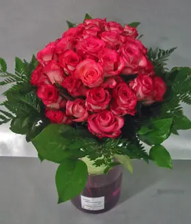 (40) pink roses in glass vase with colored water
