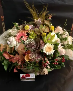 Flower arrangement with flowers & "pampas grass-cortaderia" in big basket with autumn flavor