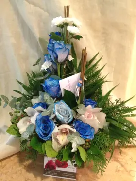 Arrangement with blue colored roses.