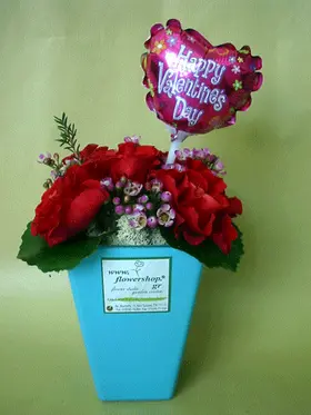 Roses in colored glass vase