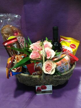 Flower arrangement in basket with Easter Gourmet Delicacies !