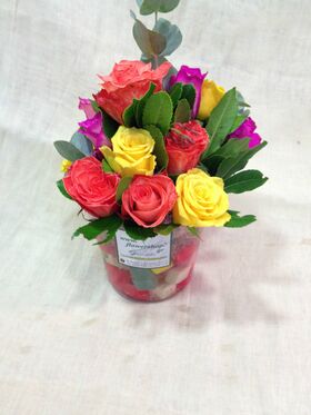 Flower salad from Colored cubes  "Oasis Moss" in glass vase with season summer flowers