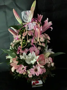 Flower arrangement in basket with season exclusive flowers