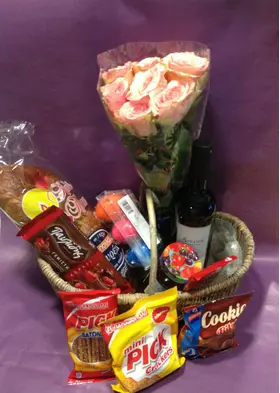 Flower arrangement in basket with Easter Gourmet Delicacies !