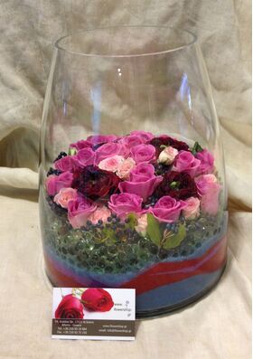 Arrangement of multi colored roses  in vase with decorative colored sand layers!!! Exclusive