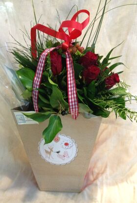 Red roses (9) stems in modern water flower bag.