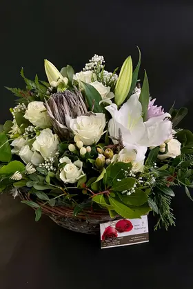 Basket with season flowers. White nature.