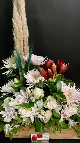 Flower arrangement in basket with season exclusive flowers