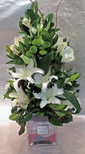 Arrangement in glass vase with white flowers
