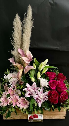 Flower arrangement in basket with season exclusive flowers