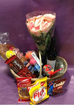 Flower arrangement in basket with Easter Gourmet Delicacies !