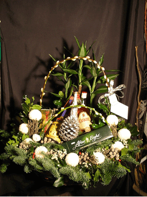 Christmas arrangement in a basket with chocolates and drinks