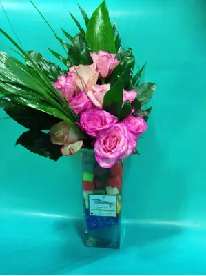 Flower salad from Colored cubes  "Oasis Moss" in glass vase with season summer flowers