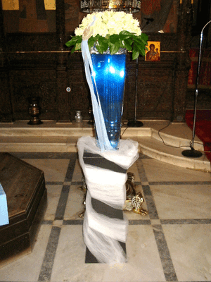 Baptismal ceremony. Flowers on vase with colored water.