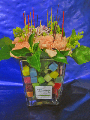Flower salad from Colored cubes  "Oasis Moss" in glass vase with season summer flowers