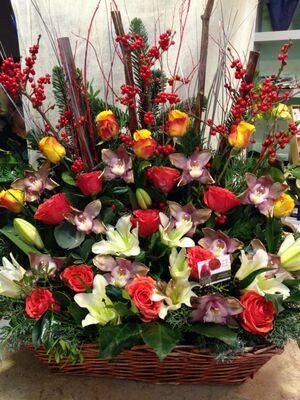 Ilex and pussy willow salix compined with season flowers in basket