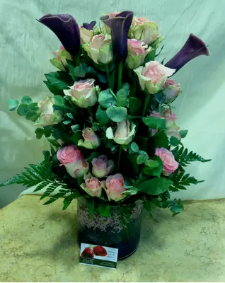 Arrangement In Glass Vase. Purple Flowers With Decorative Flower Gel.