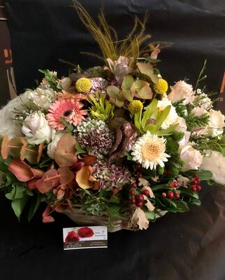 Flower arrangement with flowers & "pampas grass-cortaderia" in big basket with autumn flavor