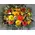 Basket with multi colored flowers and winter greens