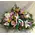 Basket with multi colored flowers and winter greens