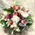 White flowers and christmas greens in basket with accessories