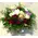 Flower arrangement in basket with season flowers and relative greens