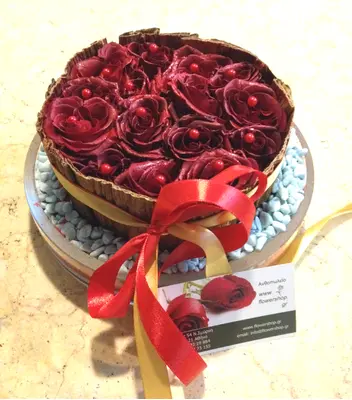 Red roses in glass with decorative banana leaves frame