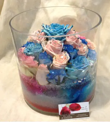 Arrangement of multi colored roses  in vase with decorative colored sand layers!!! Exclusive