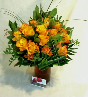 (31) orange - salmon  roses A' quality Dutch with greens in vase.