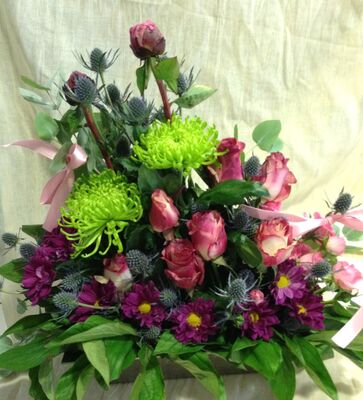 Metal pot with flowers in parallel lines.