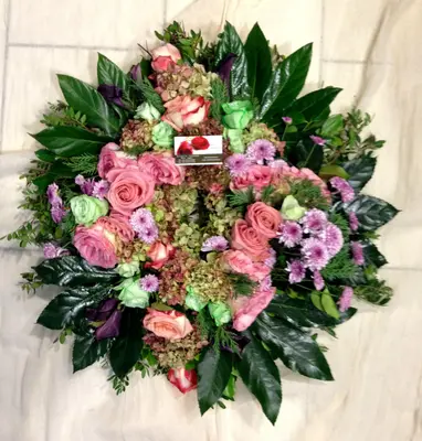 White or pink condolences wreath.