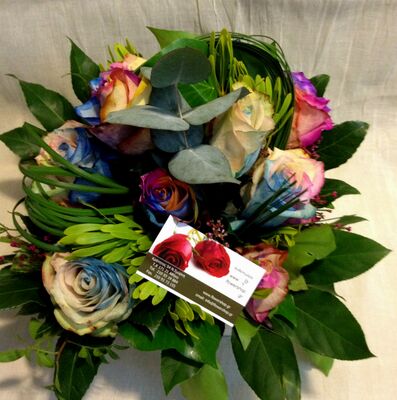 Roses "Rainbow" in basket with season flowers