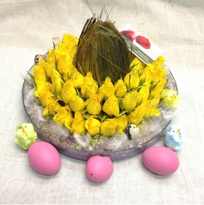 Yellow roses in glass with assorted Easter decoration
