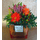 Season flowers in small glass cube vase