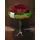 Red roses in glass vase with decorative colored pebbles layers